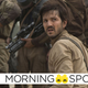 Cassian Andor kneels in front of a squad of Rebel soldiers in Rogue One: A Star Wars Story.